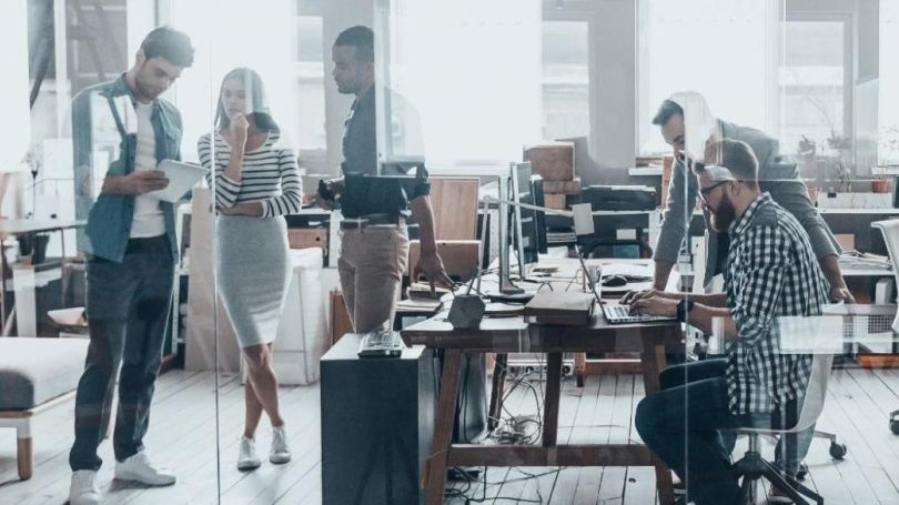 Grupo de pessoas trabalhando juntas em um laboratório de informática