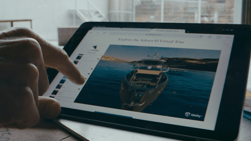 Hand pointing on ipad where a boat is visualized